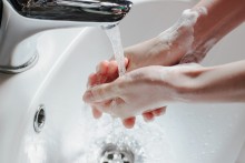 washing hands in hot water 