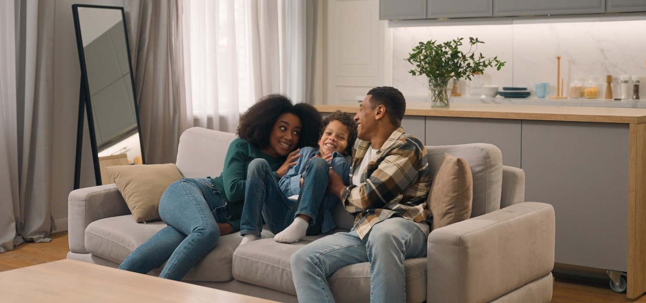 family on a couch in their warm living room