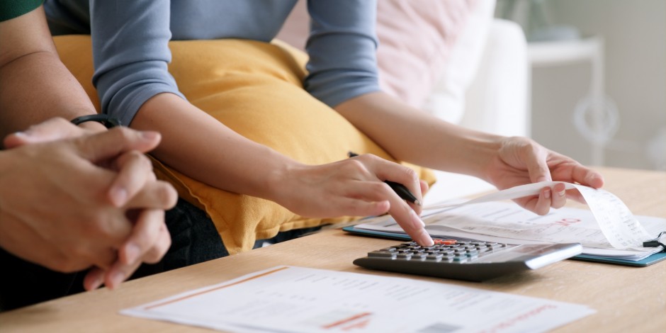 couple adding up their electric bills for the month